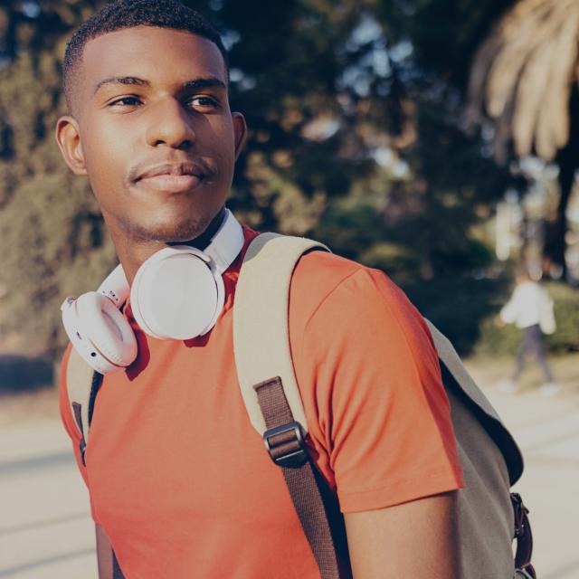 Person with headphones and backpack.