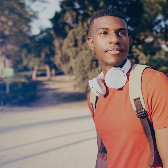 Person with headphones and backpack.