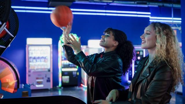 Woman prepares to toss basketball