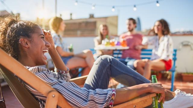 Laughing and relaxing at summer rooftop party